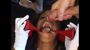 A spectacular dark-skinned brunette in red high-heeled shoes fucks with two guys in all holes filled with sperm